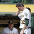 In this photo from Wednesday, Sept. 5, 2012, Oakland Athletics pitcher Brandon McCarthy (32) places his hand to his head as he leaves the baseball game against the Los Angeles Angels in Oakland, Calif. McCarthy remains in a ''life-threatening'' situation in a Bay Area hospital two days after being hit in the head by a line drive. Struck on the right side of his head by a hard shot from the Angels' Erick Aybar, McCarthy suffered an epidural hemorrhage, brain contusion and skull fracture. He had two hours of surgery to relieve pressure on his brain late Wednesday night. A's athletic trainer Nick Paparesta was asked Friday if McCarthy was still in a life-threatening situation. "Absolutely he is. It's brain surgery,'' Paparesta said. ''It's life-threatening. At any possible moment something could go wrong, he could have a complication. Absolutely.'' (AP Photo/Ben Margot)