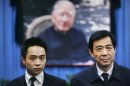 File photo shows Bo Xilai and his son Bo Guagua at a mourning hall in Beijing