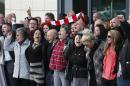 Relatives of those who died in the Hillsborough disaster sing 'You'll Never Walk Alone' outside outside the Hillsborough Inquest in Warrington, England, Tuesday April 26, 2016. The 96 Liverpool soccer fans who died in the Hillsborough Stadium disaster were "unlawfully killed" because of errors by the police, a jury concluded Tuesday. (Joe Giddens/PA via AP) UNITED KINGDOM OUT