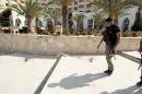 A police officer walks past blood at the Imperiale Marhaba hotel after a gunman opened fire at the beachside hotel in Sousse, Tunisia
