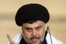 Iraqi Shi'ite radical leader Sadr delivers a sermon to worshippers during Friday prayers near Najaf