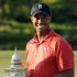Tiger Woods poses with the trophy on the 18th green after winning the AT&T National golf tournament at Congressional Country Club in Bethesda, Md., Sunday, July 1, 2012. (AP Photo/Nick Wass)