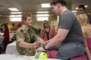 Wearing his British Army uniform, Britain's Prince Harry visits with wounded warriors undergoing physical therapy at the Military Advanced Training Center at Walter Reed National Military Medical Center in Bethesda, Md., just outside Washington, Friday, May 10, 2013. At right is Staff Sgt. Timothy Payne who lost his legs in an IED explosion in Afghanistan. (AP Photo/J. Scott Applewhite, Pool)