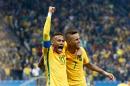 Brazil's Luan (R) celebrates with teammate Neymar after scoring a goal against Colombia during their Rio 2016 Olympic Games quarter-final match, at the Corinthians Arena in Sao Paulo, on August 13