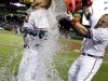 Atlanta Braves' Freddie Freeman, left, is doused with water by Eric Hinske after Freeman hit a home run in the ninth inning as the Braves beat the Marlins 4-3 to clinch at least an NL wild-card playoff berth Tuesday, Sept. 25, 2012, in Atlanta. (AP Photo/David Goldman)