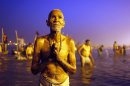 A Hindu devotee prays after a holy dip at 'Sangam', the confluence of Hindu holy rivers Ganges, Yamuna and the mythical Saraswati, during the Maha Kumbh festival at Allahabad, India, Sunday, Feb. 10, 2013. Led by heads of monasteries arriving on chariots and ash-smeared naked ascetics, millions of devout Hindus plunged into the frigid waters of the holy Ganges River in India on Sunday in a ritual that they believe will wash away their sins. Sunday was the third of six auspicious bathing days during the Kumbh Mela, or Pitcher Festival, which lasts 55 days and is one of the world's largest religious gatherings. (AP Photo /Rajesh Kumar Singh)