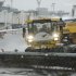 Grounds crews clear the tarmac at LaGuardia Airport in New York Friday, Feb. 8, 2013. Airlines scratched more than 3,700 flights in the Northeast through Saturday as snow began falling in what was predicted to be a huge blizzard that could dump 1 to 3 feet of snow from New York City to Boston and beyond. (AP Photo/Frank Franklin II)