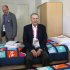 In this Monday, July 23, 2012 photo, IOC President Jacques Rogge, center, sits on a bed as he is accompanied by Charles Allen, village mayor, during his visit to the Athletes' Village at the Olympic Park, in London. More than 1 million items from the athletes village and Olympics Park are on sale here, and they'll be ready for collection right after the Paralympic Games end in early September. Included are: night stands, lamps, umpire's chairs and even beanbags. (AP Photo/Jae C. Hong)