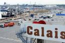 Trucks prepare to load into a ferry in the port of Calais, northern France, on August 20, 2013