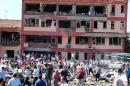 Members of the public and police inspect the site of a car bomb attack on a police station in the eastern Turkish city of Elazig on August 18, 2016
