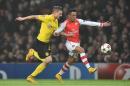 Arsenal's Chilean striker Alexis Sanchez (R) vies with Dortmund's Polish defender Lukasz Piszczek during their UEFA Champions League Group D football match at the Emirates Stadium in north London on November 26, 2014