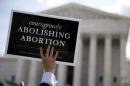 File photo of an anti-abortion protester holding sign outside U.S. Supreme Court t in Washington