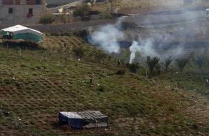 Smoke rises as workers burn stalks of cannabis in Lazarat, …