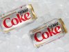 This Monday, Oct. 15, 2012 photo shows two cans of Caffeine Free Diet Coke on ice in Surfside, Fla. Coca-Cola is expected to report earnings, Tuesday, Feb. 12, 2013. (AP Photo/Wilfredo Lee)