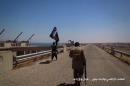 An image from a video released by Welayat Nineveh Media Office on August 9, 2014, allegedly shows Islamic State militants inspecting the grounds of the Mosul dam on the Tigris river, north of the city