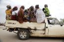 Women travel in the back of a truck in the town of Mararaba, after the Nigerian military recaptured it from Boko Haram, in Adamawa state