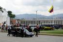 The hearse with the remains of late Venezuelan President Hugo Chavez is taken from the Military Academy to his resting place at the former "4 de Febrero" barracks in Caracas, on March 15, 2013
