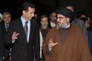 FILE -- In this Thursday February 25, 2010 file photo, released by the Syrian official news agency SANA, Hezbollah leader sheik Hassan Nasrallah, right, speaks with Syrian President Bashar Assad, left, upon their arrival for a dinner, in Damascus, Syria. The powerful alliance of Iran, Syria and militant groups Hezbollah and Hamas, once dubbed the "Axis of Resistance," is fraying. Iran's economy shows signs of distress from nuclear sanctions, Syria's president is fighting for his survival, Hezbollah is under fire by Lebanese who blame it for the assassination of an anti-Syrian intelligence official and Hamas _ the Palestinian arm _ has bolted. (AP Photo/SANA, File)
