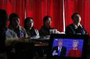 Chinese students watch live broadcasting of the U.S. presidential debate between Democratic presidential nominee Hillary Clinton and Republican presidential nominee Donald Trump, at a cafe in Beijing, Tuesday, Sept. 27, 2016. (AP Photo/Andy Wong)