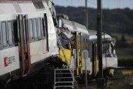 <p>Two trains collided head-on July 29, 2013 in Granges-pres-Marnand, western Switzerland, injuring 35 passengers, at least five of them seriously, police said. Rescue workers at the site have found the body of one of the drivers, police said early Tuesday.</p>