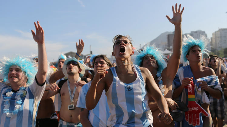 Argentine soccer fans react as they watch a live telecast of their team&#39;s World Cup match against Nigeria inside the FIFA Fan Fest area on Copacabana beach, in Rio de Janeiro, Brazil, Wednesday, June 25, 2014. Argentina won 3-2. (AP Photo/Leo Correa)