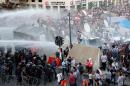 Lebanese security forces use water cannons to disperse protesters during a demonstration, organised by the "You Stink" campaign, against the ongoing trash crisis in Beirut on August 22, 2015