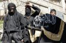 A picture taken on October 25, 2013 shows members of jihadist group Al-Nusra Front taking part in a parade in Aleppo