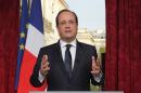 French President Francois Hollande gestures after he recorded a speech to be broadcast on French television on March 31, 2014