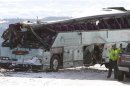Tow truck operators work on wrecked tour bus in Oregon