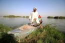 An Iraqi man gets off a boat in the Iraqi Marshlands -- one of the world's largest inland delta systems