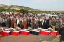 Picture released by the official Syrian Arab News Agency (SANA) allegedly shows Syrian officials attending the funeral of civilians killed on February 9 in the Syrian village of Maan, at an undisclosed location in Hama province