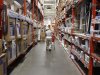 A man pushes his shopping cart down an aisle at a Home Depot store in New York