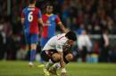 Liverpool's Luis Suarez, holds his shirt to his face following the end of the English Premier League soccer match between Crystal Palace and Liverpool at Selhurst Park stadium in London, Monday, May 5, 2014. The game ended in a 3-3 draw. (AP Photo/Alastair Grant)