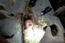 Still image of an abandoned newborn baby boy seen in a sewage pipe following his rescue in Jinhua city