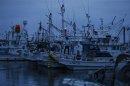 A fisherman stands on his boat in Hisanohama port in Iwaki, about 30 km (19 miles) south of the Fukushima Daiichi nuclear power plant, Fukushima prefecture