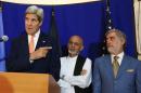 FILE - In this Friday, Aug. 8, 2014 file photo, U.S. Secretary of State John Kerry, left, speaks as Afghan presidential candidates Ashraf Ghani Ahmadzai, center, and Abdullah Abdullah listen during a joint press conference in Kabul, Afghanistan. "Radicals" backing Abdullah could foment postelection violence if he isn't given an equitable share of power, his spokesman warned Saturday, Sept. 6, 2014 ahead of a meeting with his rival aimed at resolving a monthslong election dispute. U.S. Secretary of State John Kerry helped broker an agreement this summer under which all 8 million ballots would be recounted, a process which was concluded Friday. (AP Photo/Rahmat Gul, File)