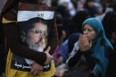A supporter of deposed Egyptian President Mursi holds picture during protest in Cairo