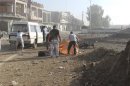 Residents remove the body of a man lying on the ground after a Syrian Air Force fighter jet loyal to Syria's President Bashar al-Assad fired missiles at Houla