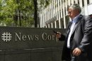 A man walks past the News Corporation building in New York