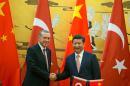 Chinese President Xi Jinping (right) and Turkey's President Recep Tayyip Erdogan shake hands as they attend a signing ceremony at the Great Hall of the People in Beijing, on July 29, 2015