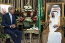Saudi King Abdullah talks with U.S. Secretary of State Kerry talk before a meeting at the Royal Palace in Jeddah