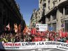 People hold banners and placards as they march during a protest against government austerity measures in Barcelona