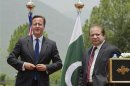 British Prime Minister Cameron poses next to his Pakistani counterpart Sharif after a joint news conference at the prime minister's residence in Islamabad
