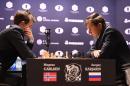Chess grandmaster and current world chess champion Magnus Carlsen of Norway and challenger Sergey Karjakin of Russia concentrate during their World Chess Championship 2016 round 1 match in New York on November 11, 2016