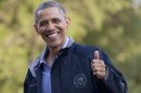President Barack Obama give the thumbs up as walks from Marine One the the White House, Friday, July 26, 2013, in Washington, as he arrives after spending the day at Camp David with members of his cabinet and their families. (AP Photo/Carolyn Kaster)