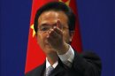 China's Foreign Ministry spokesman Hong asks journalists for questions during a news conference in Beijing
