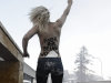 An activist of the Ukrainian feminist  group FEMEN stands on a fence during a protest at the 43rd Annual Meeting of the World Economic Forum, WEF, in Davos, Switzerland, Saturday, Jan. 26, 2013.  (AP Photo/Keystone/Jean-Christophe Bott)
