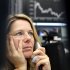 A trader makes a phone call at the stock market in Frankfurt, Germany, Tuesday, Nov. 15, 2011, where the curve of the German stock index went down in the morning but went up again in the afternoon.(AP Photo/Michael Probst)