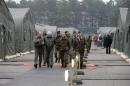 Military personnel walk in a military base during the "Steadfast Jazz" military exercise in Adazi