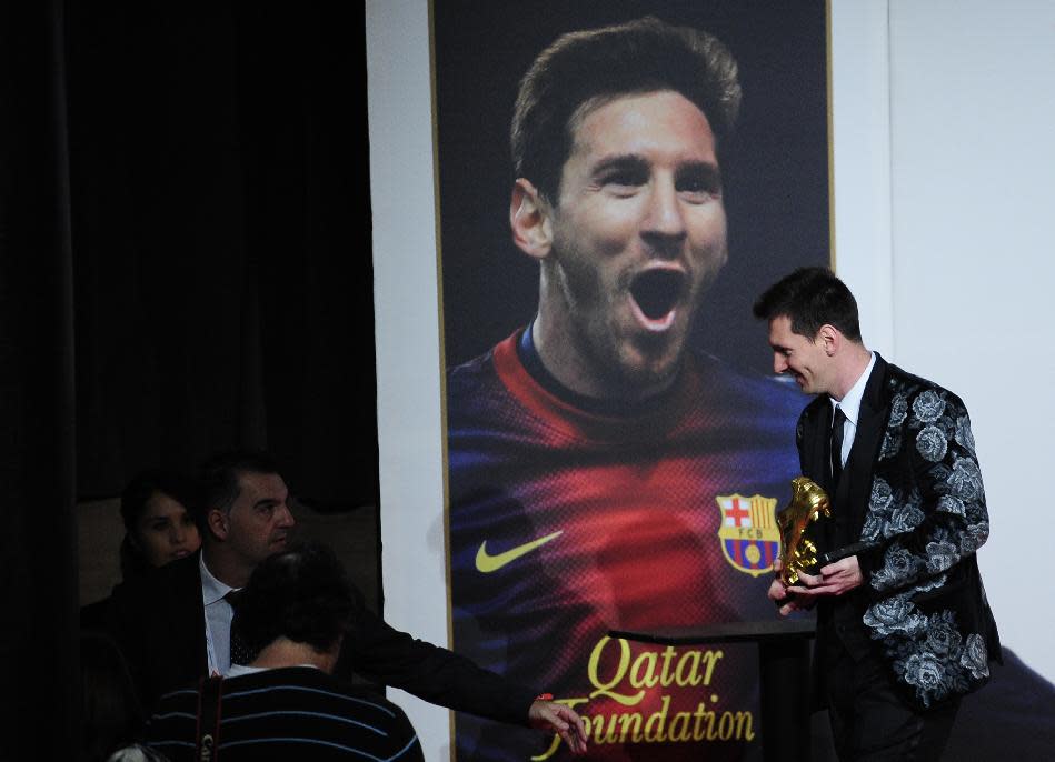 Barcelona's Lionel Messi from Argentina poses for the media after receiving his Golden Boot award for scoring the most goals in Europe's domestic leagues last season in Barcelona, Spain, Wednesday, Nov. 20, 2013